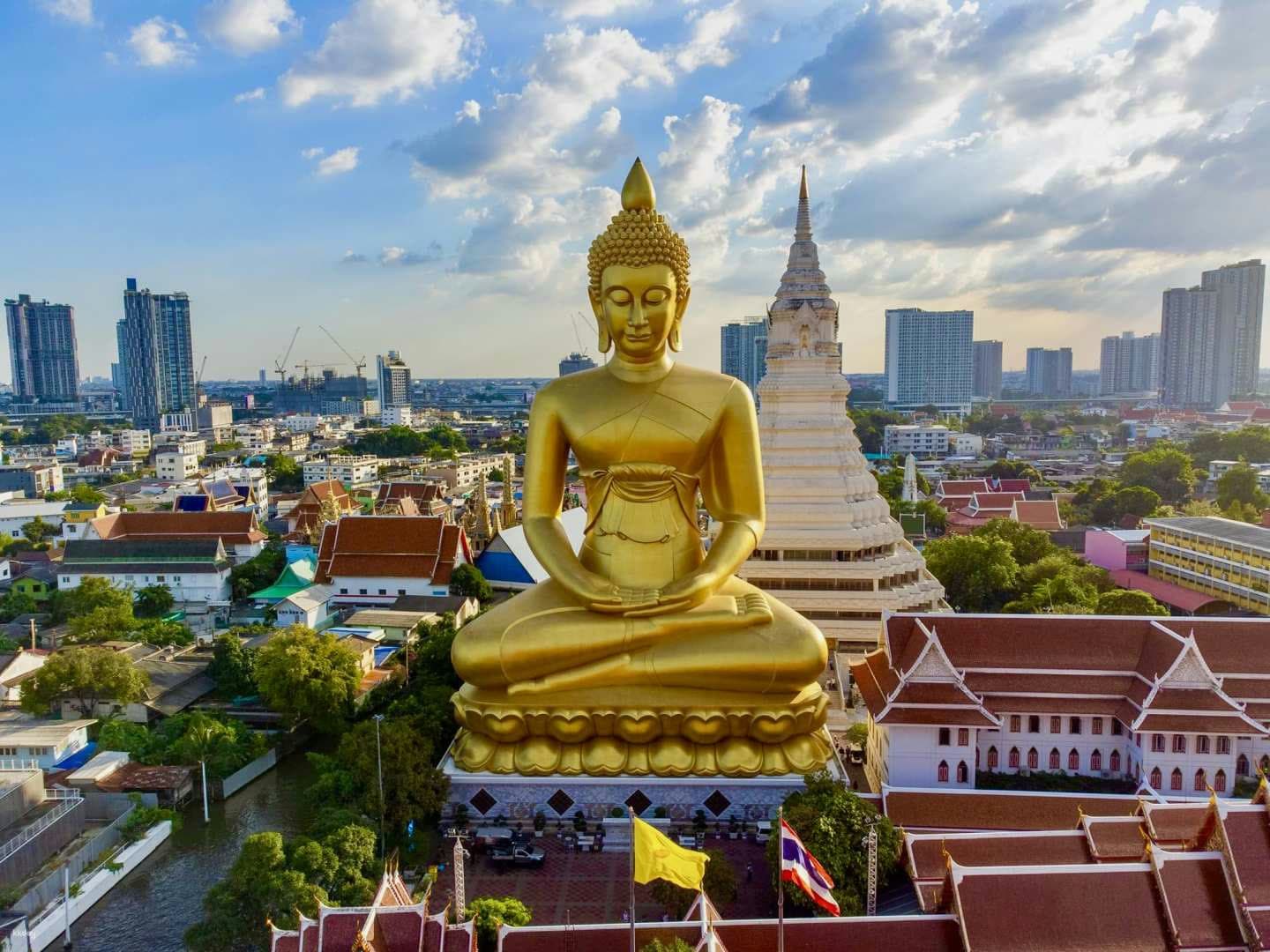 Golden Buddha statue rising above the Bangkok skyline
