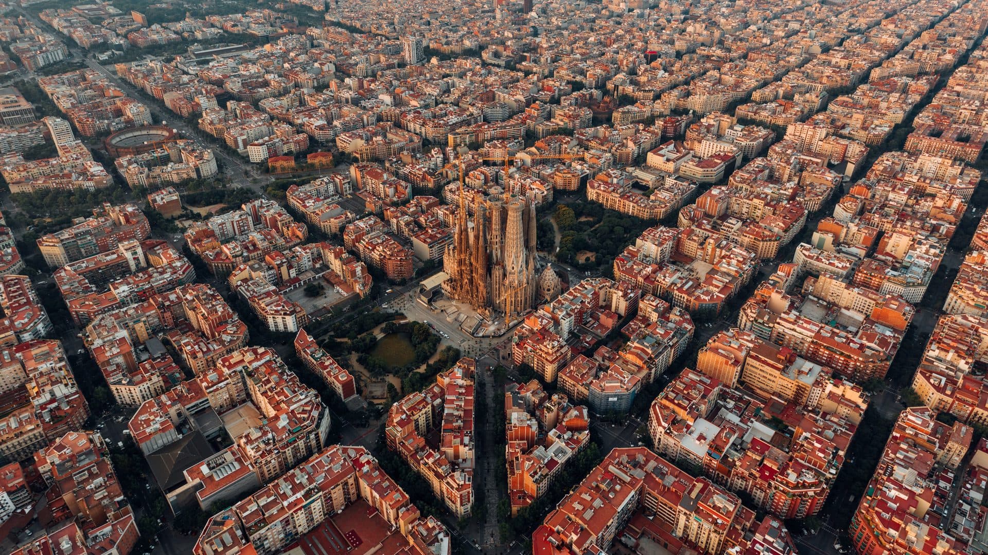 Aerial view of Barcelona's Eixample grid with the Sagrada Família at its center