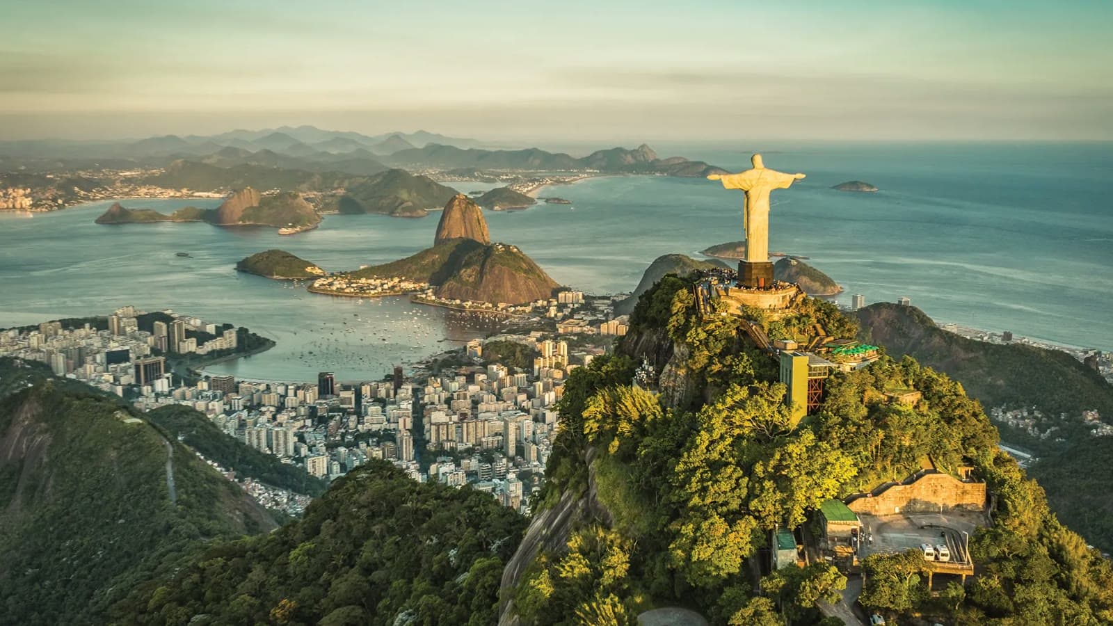 Aerial view of Christ the Redeemer atop Corcovado overlooking Rio de Janeiro's bay and Sugarloaf Mountain