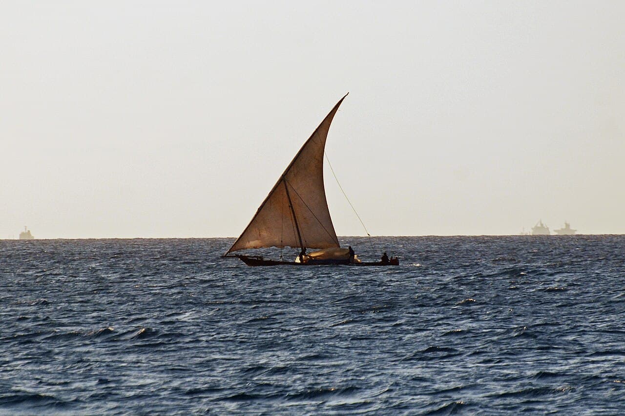 A traditional dhow sailing off the coast of Zanzibar at sunset